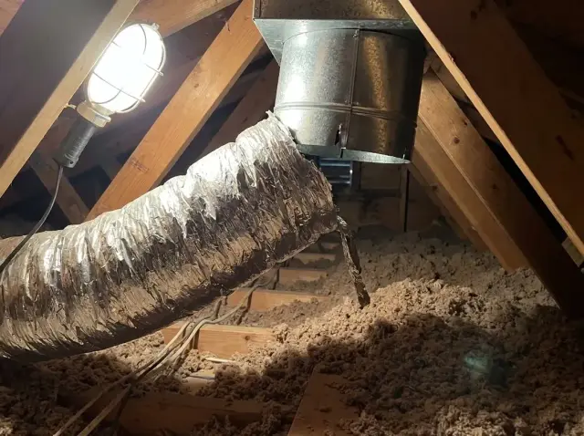 Ducto separado en el ático soplando sobre el aislamiento
