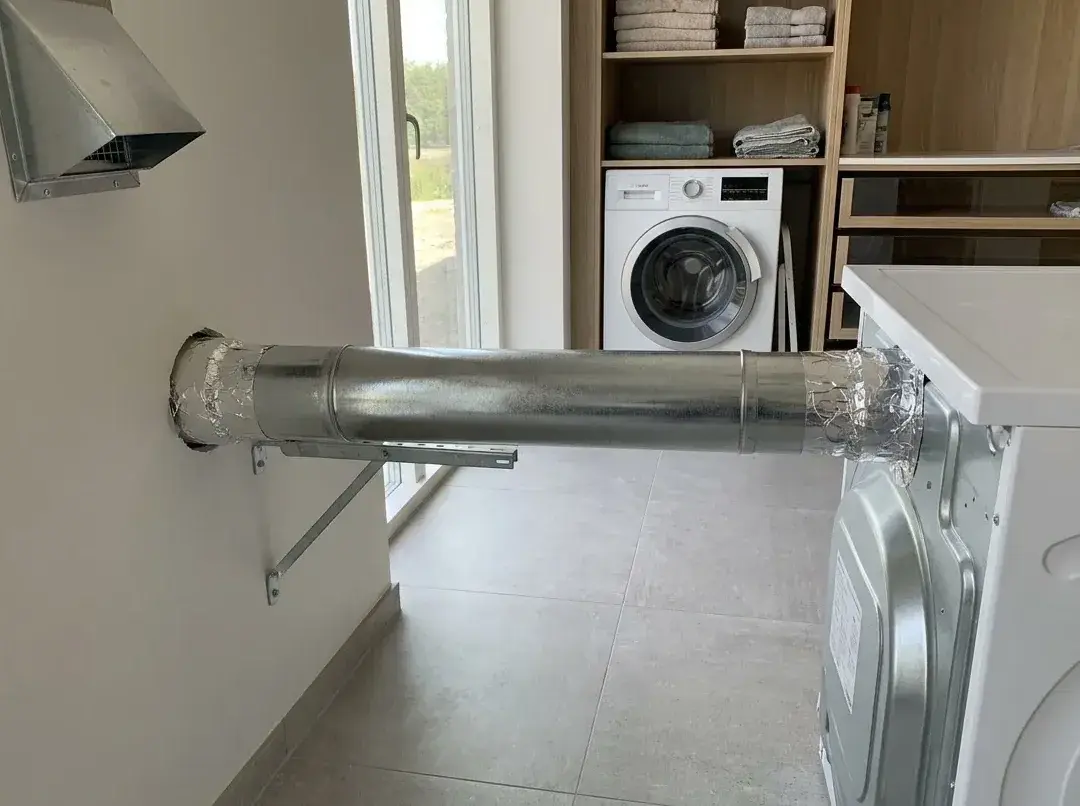 New rigid metal dryer duct installed from the dryer to the wall